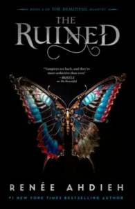 book cover with a Purple, black and light blue metal butterfly with wings spread out and the title in silver gray "The Ruined"